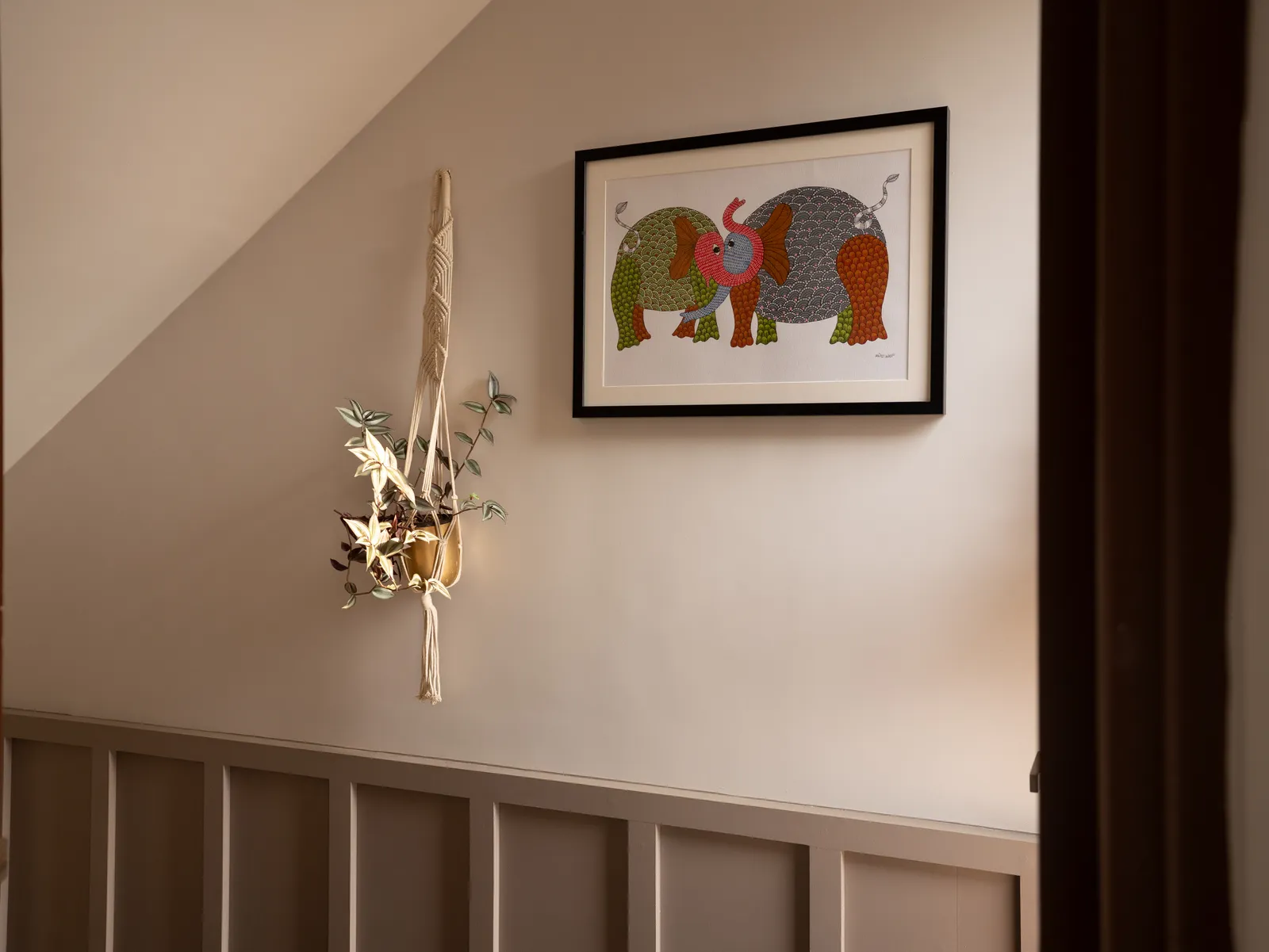 Staircase landing with wall panelling and framed artwork — Amlan's Residence